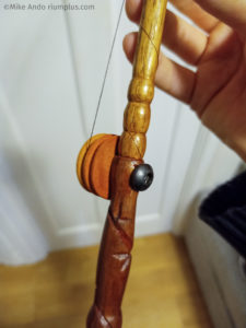 The handle of The Dabber. The enamelled copper wire terminates at a metal bolt, which also holds the spindle. Rotating the spindle pulls the thread and bends the tip in that direction.